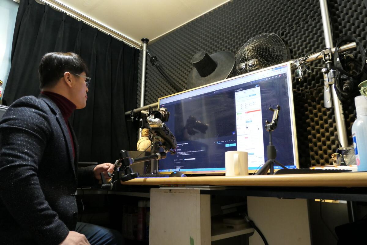 Mun Jung-ho sets up for a live YouTube broadcast at his home studio in Seoul. Mun, a 52-year-old voice actor, creates videos as "YouTube Dad" in his soothing baritone, offering a human connection to his more than 50,000 subscribers.