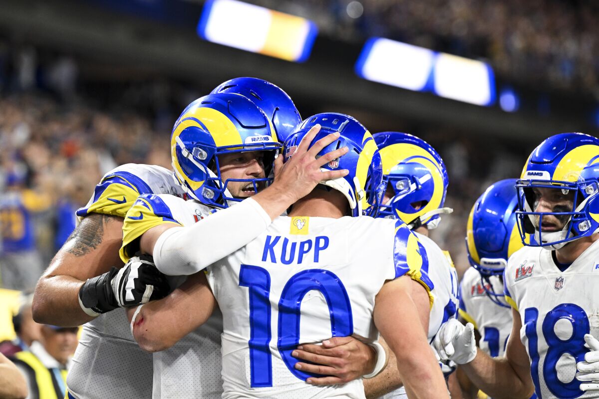 Rams quarterback Matthew Stafford and teammates congratulate Cooper Kupp after a touchdown catch.
