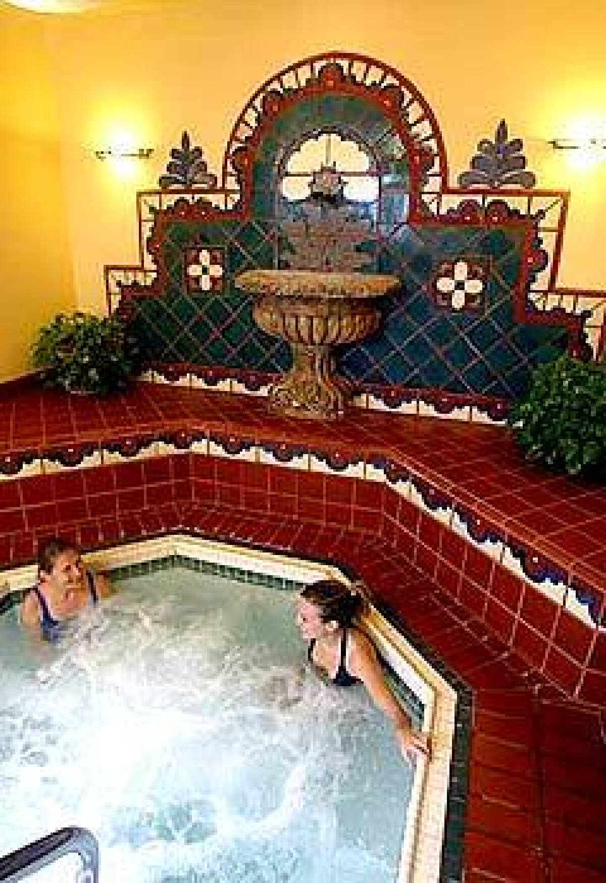 Judy Blades, left, and her daughter Lisa relax in the Oaks whirlpool room, which has new retro-Spanish tile.