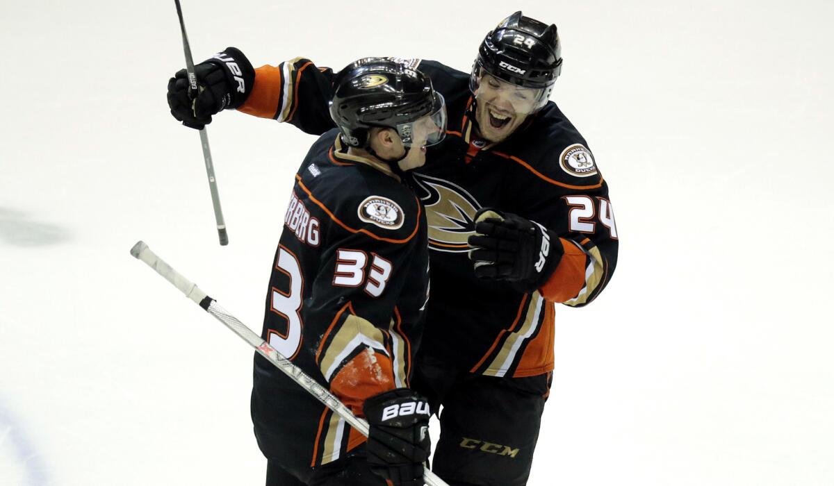 Ducks right wing Jakob Silfverberg (33) celebrates with defenseman Simon Despres after scoring the winning goal against the Jets with 21 seconds left in Game 2 on Saturday night in Anaheim.