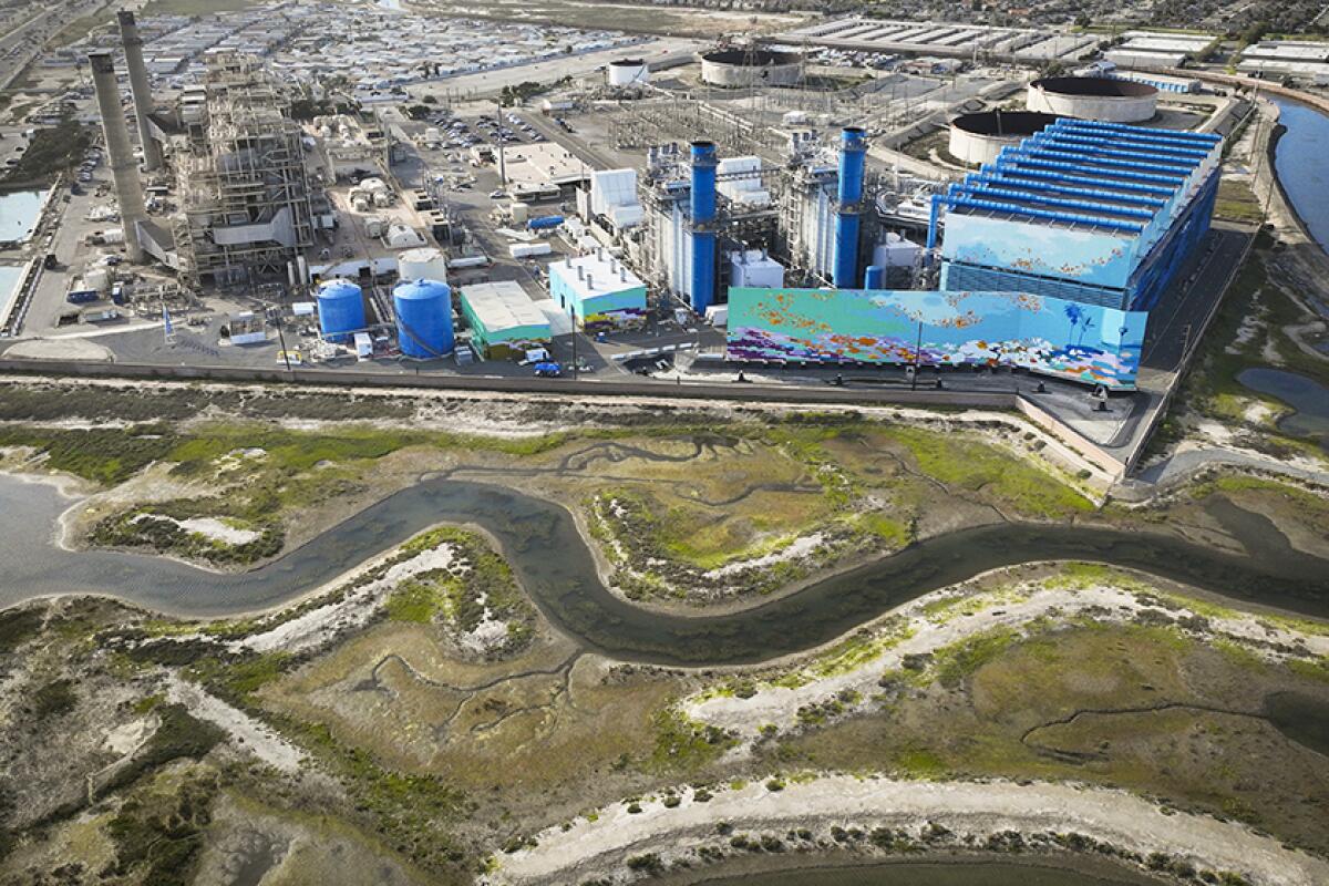 An aerial view of wetlands next to a power station