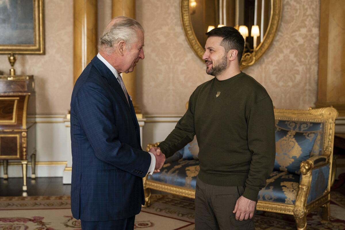 Britain's King Charles III shakes hands with Ukrainian President Volodymyr Zelensky.