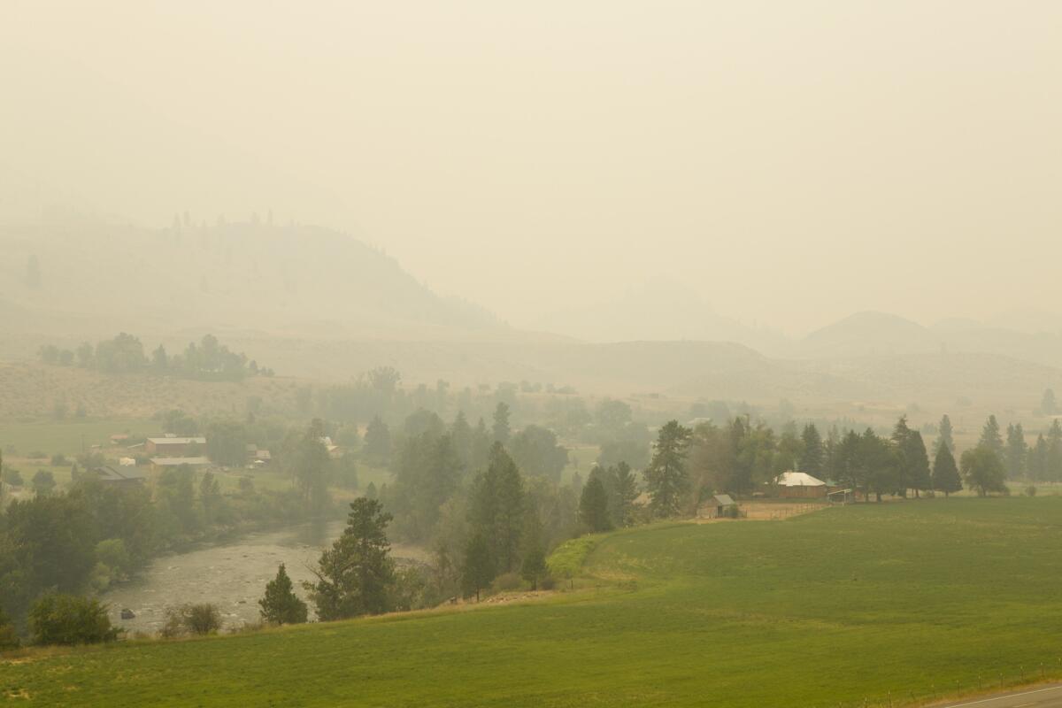 Smoke from the Carlton Complex fire covers Methow Valley near Twisp, Wash., on Sunday.