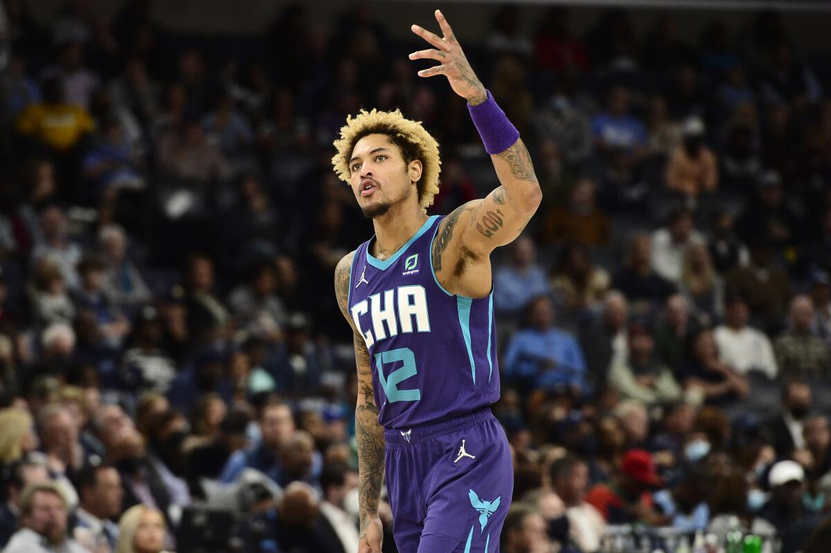 Charlotte Hornets guard Kelly Oubre Jr. (12) reacts after scoring a three point basket in the second half of an NBA basketball game against the Memphis Grizzlies Wednesday, Nov. 10, 2021, in Memphis, Tenn. (AP Photo/Brandon Dill)