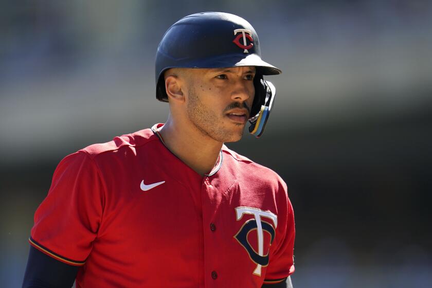 Minnesota Twins' Carlos Correa reacts while batting during the first inning of a baseball game against the Chicago White Sox