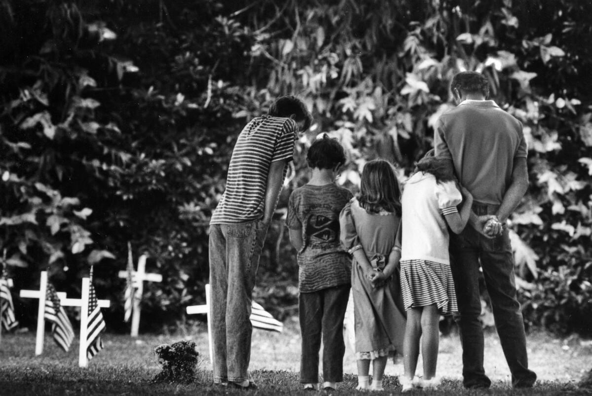 May 27, 1991: The Weber family, from left, Eric, 14, Joseph, 9, Melissa, 7, Jennifer, 10, and their father, Dennis Webber, visit the grave of their grandparents at Loma Vista Memorial Park during Memorial Day.