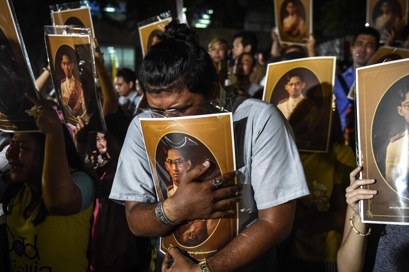 Thai people react as they hear the news of the death of Thailand's King Bhumibol Adulyadej outside Siriraj Hospital in Bangkok on Thursday.