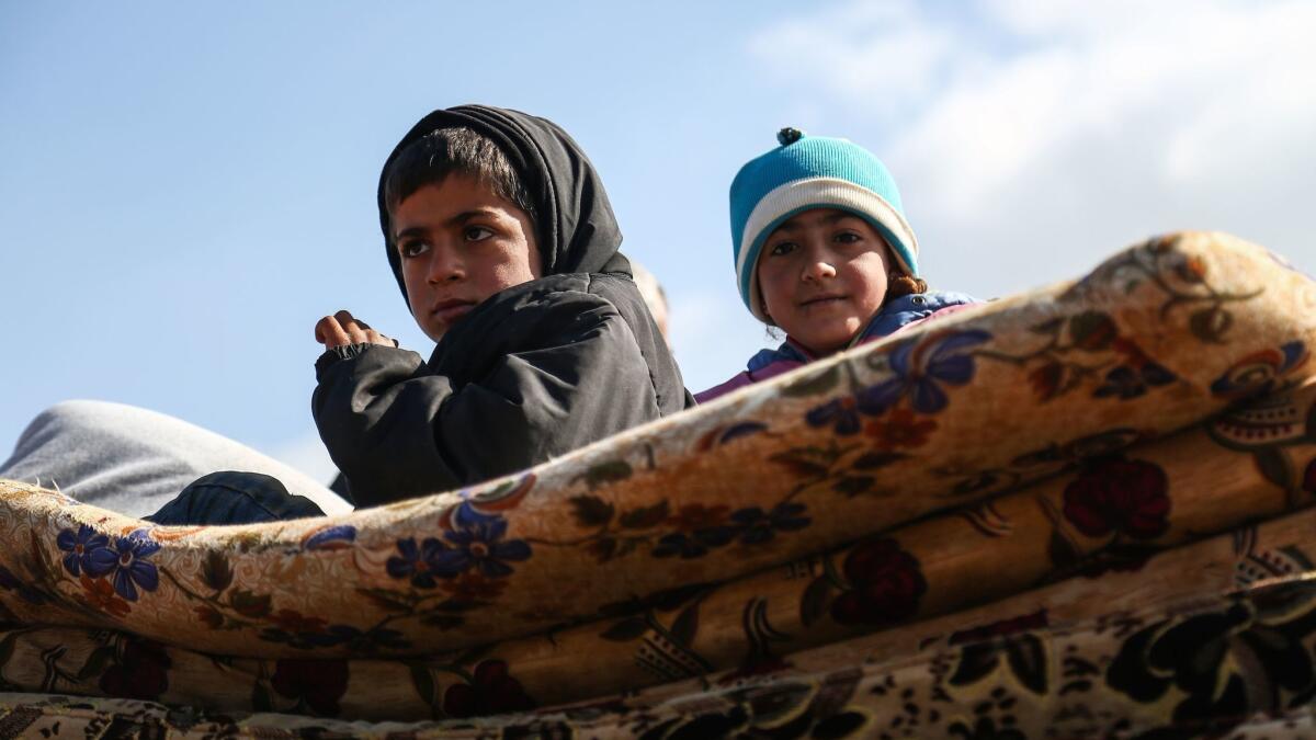Displaced children from the Kurdish-majority city of Afrin in northern Syria, which is nearly surrounded by Turkish-led forces