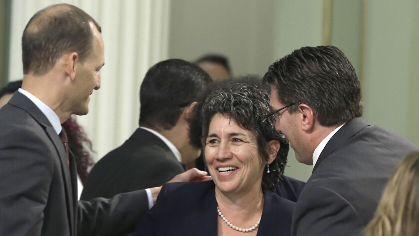 Assemblywoman Susan Talamantes Eggman (D-Stockton) is congratulated by Assemblymen Kevin McCarty (D-Sacramento), left, and Jay Obernolte (R-Big Bear Lake) after her right-to die measure was approved by the full Assembly in September.