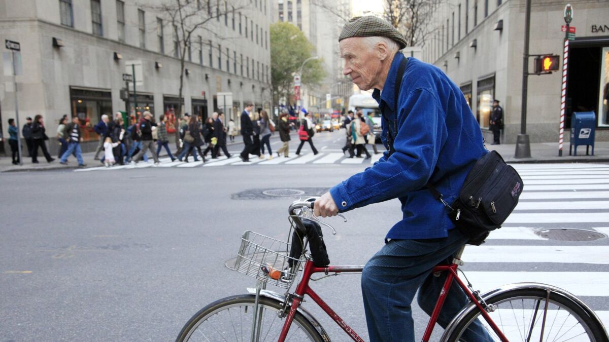 Bill Cunningham bicycling in New York in 2010. In "Fashion Climbing" he celebrates clothes, the women who inspired him and dishes delightfully on the New York social scene.
