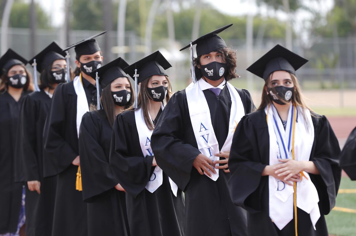 Early College High School graduates enter Jim Scott Stadium at Estancia High for their 2021 commencement ceremony Thursday.