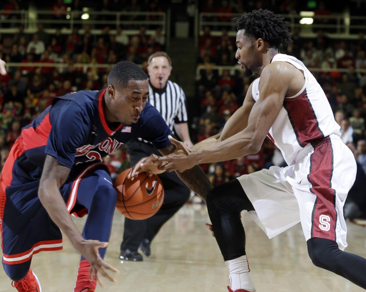Arizona forward Rondae Hollis-Jefferson strips the ball away from Stanford guard Chasson Randle during the second half of the Wildcats' 89-82 win over the Cardinal.