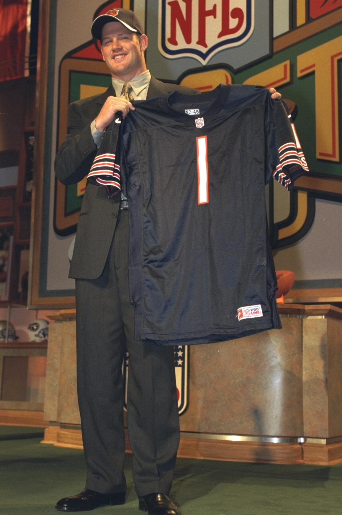 Cade McNown holds his new Chicago Bears jersey during the 1999 NFL draft in New York. 