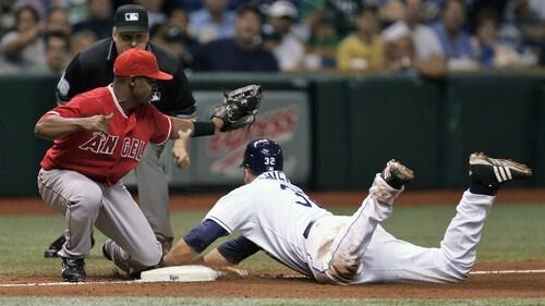 Chone Figgins tags out Tampa Bay's Eric Hinske attempting to steal third base during the fourth inning.