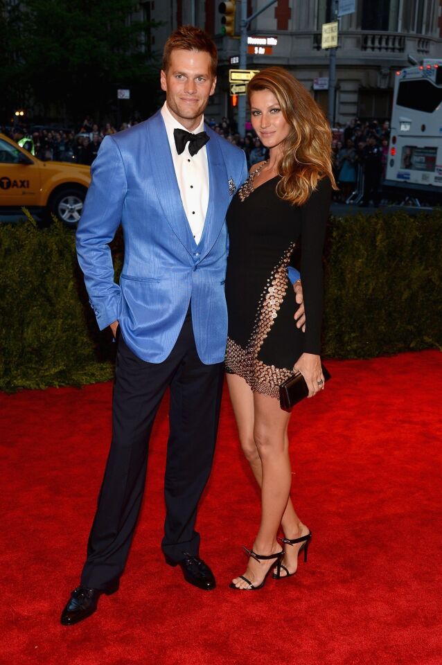 Tom Brady and Gisele Bundchen. Bundchen is wearing an Anthony Vacarello dress.