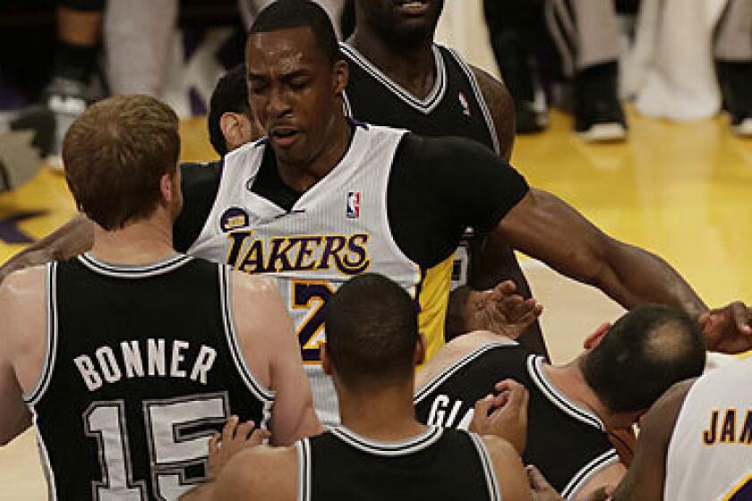 Lakers center Dwight Howard smacks Manu Ginobili of the Spurs, resulting in a technical foul, in the first quarter of Sunday's game.