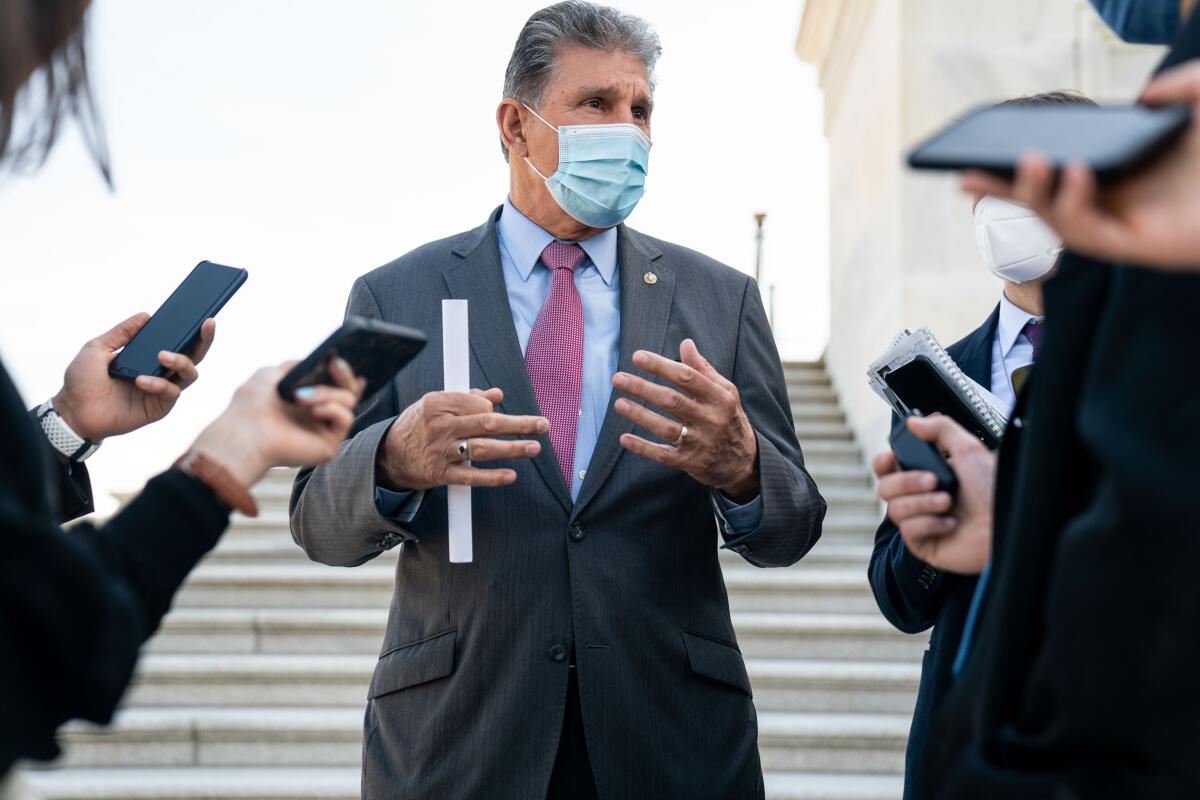 Sen. Joe Manchin speaks with reporters outside the U.S. Capitol on April 13. 