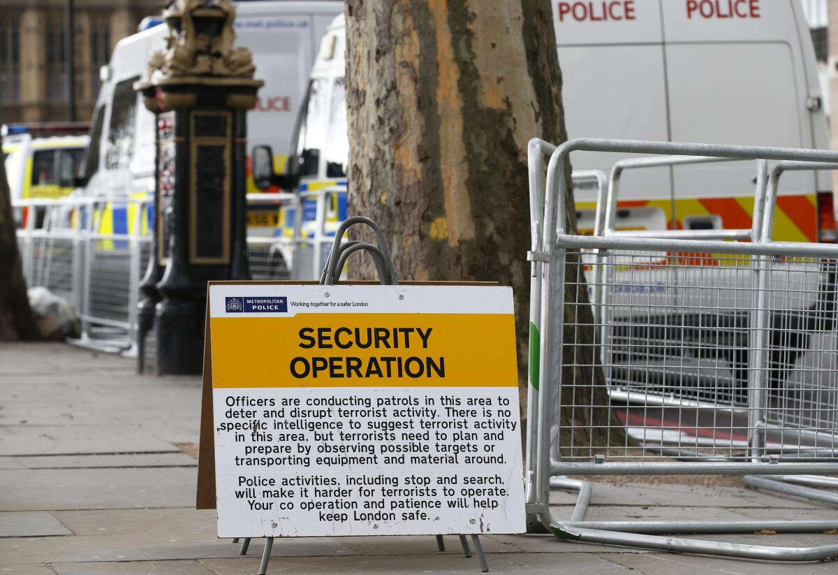 A sign Tuesday along the route of the London Marathon warns of security patrols. British police are reviewing security plans for Sunday's marathon, the next major international marathon after Boston's.