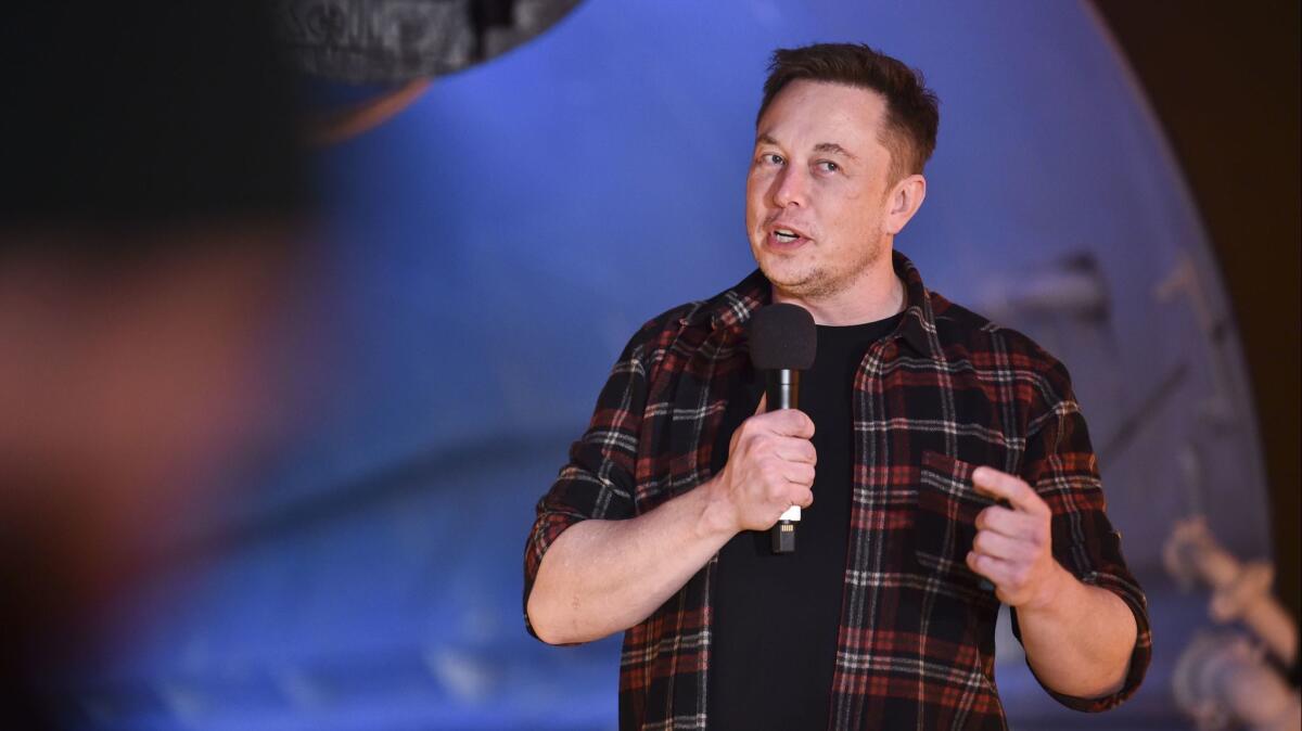 Elon Musk speaks at the unveiling of an underground test tunnel in Hawthorne on Tuesday. But when will he focus on building cars?
