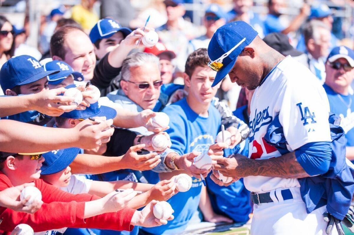 Carl Crawford signs some autographs at spring training.