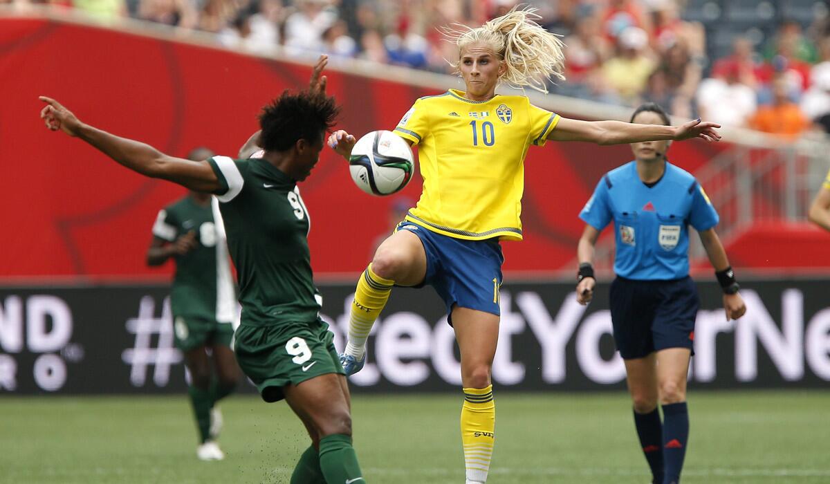 Sweden's Sofia Jakobsson (10) goes up for the ball against Nigeria's Desire Oparanozie (9) during the second half of a FIFA Women's World Cup soccer match on Monday.