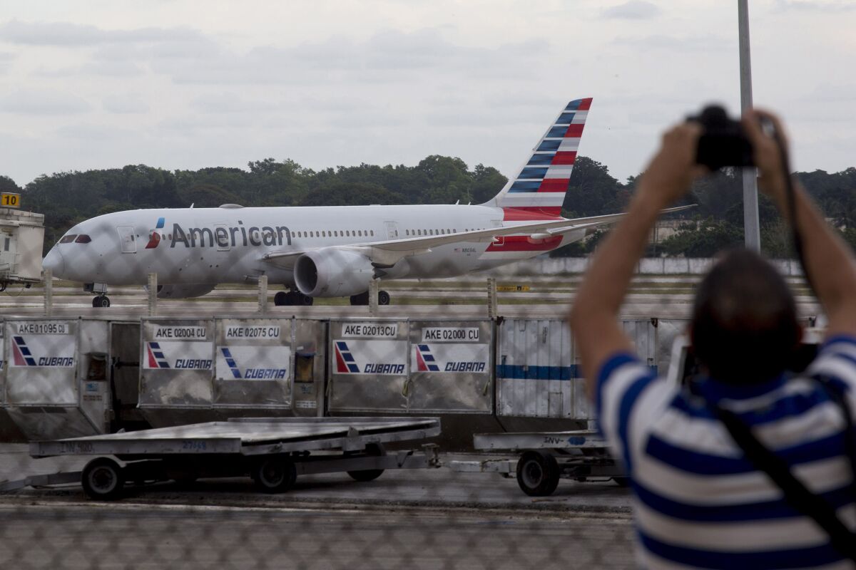 FILE - An American Airlines flight that took off from Miami sits on the tarmac at the Jose Marti International Airport in Havana, Cuba, on Nov. 15, 2021. The U.S. government is giving American Airlines permission to resume flights to five cities in Cuba outside the capital of Havana. (AP Photo/Ismael Francisco, File)