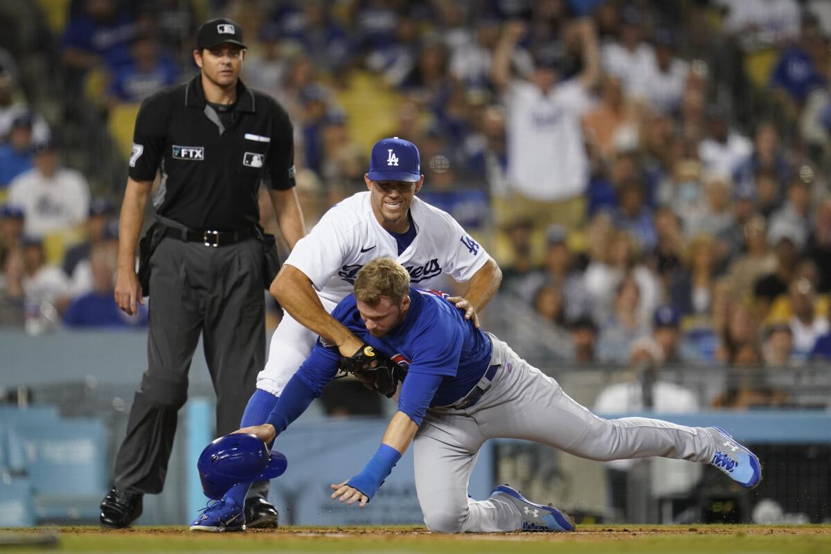 Dodgers pitcher Tyler Anderson tags Chicago Cubs outfielder Ian Happ during a game on July 8, 2022, at Dodger Stadium.