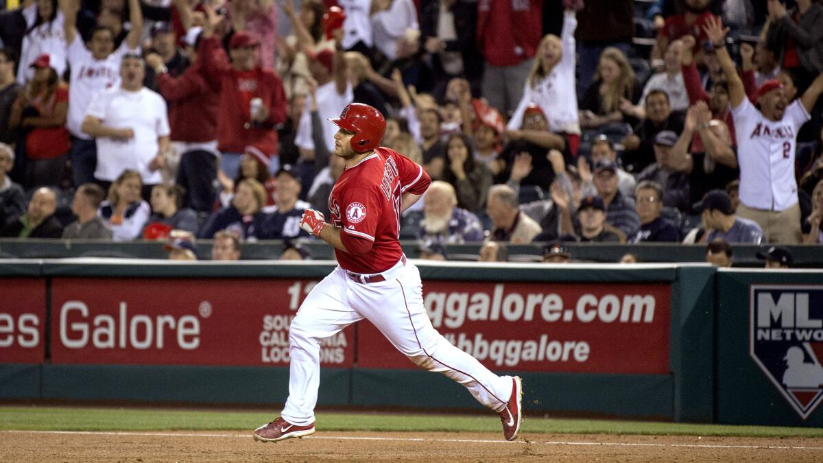 Angels catcher Chris Iannetta rounds first base after hitting a grand slam against the Detroit Tigers on Thursday night during a 12-2 win in Anaheim.