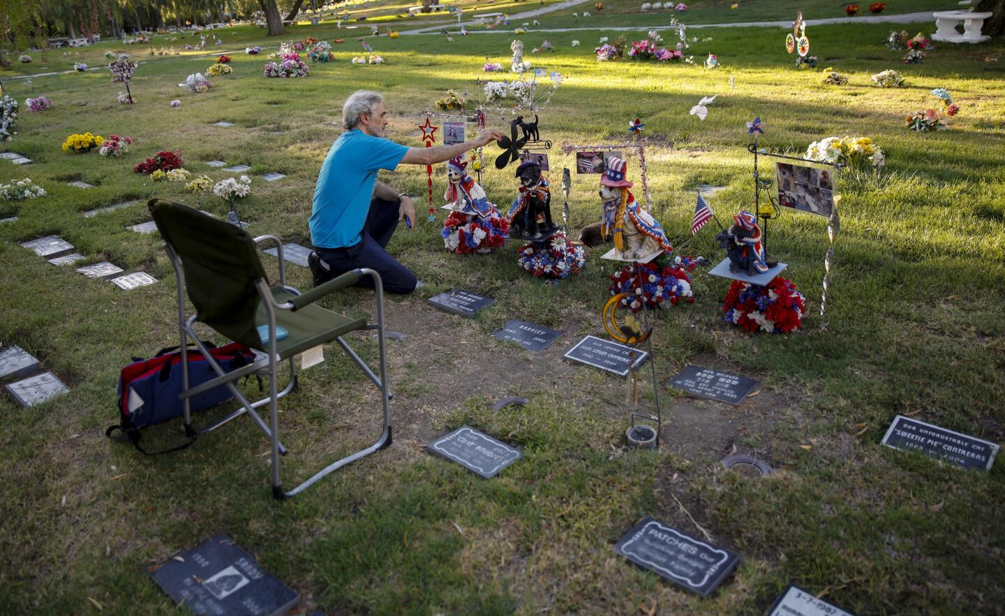 Fred Wodnicki of North Hollywood tends to the decorations he maintains where his four pets are buried at Los Angeles Pet Memorial Park in Calabasas. Wodnicki has been coming most Saturdays since 2006, changing the decorations to coordinate with the holidays.