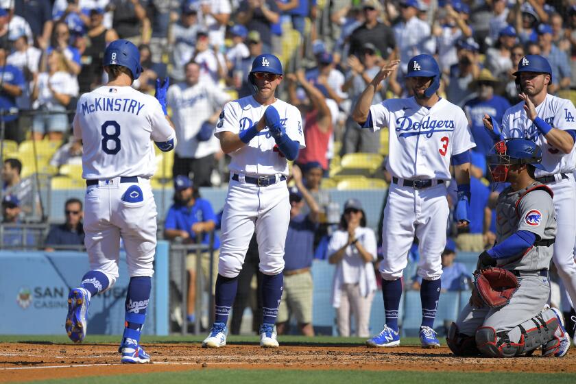 Los Angeles Dodgers' Zach McKinstry, left, celebrates along with Matt Beaty, second from left, Chris Taylor.