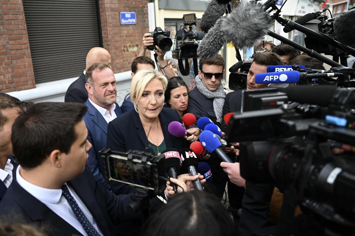 French far-right leader Marine Le Pen addresses reporters.