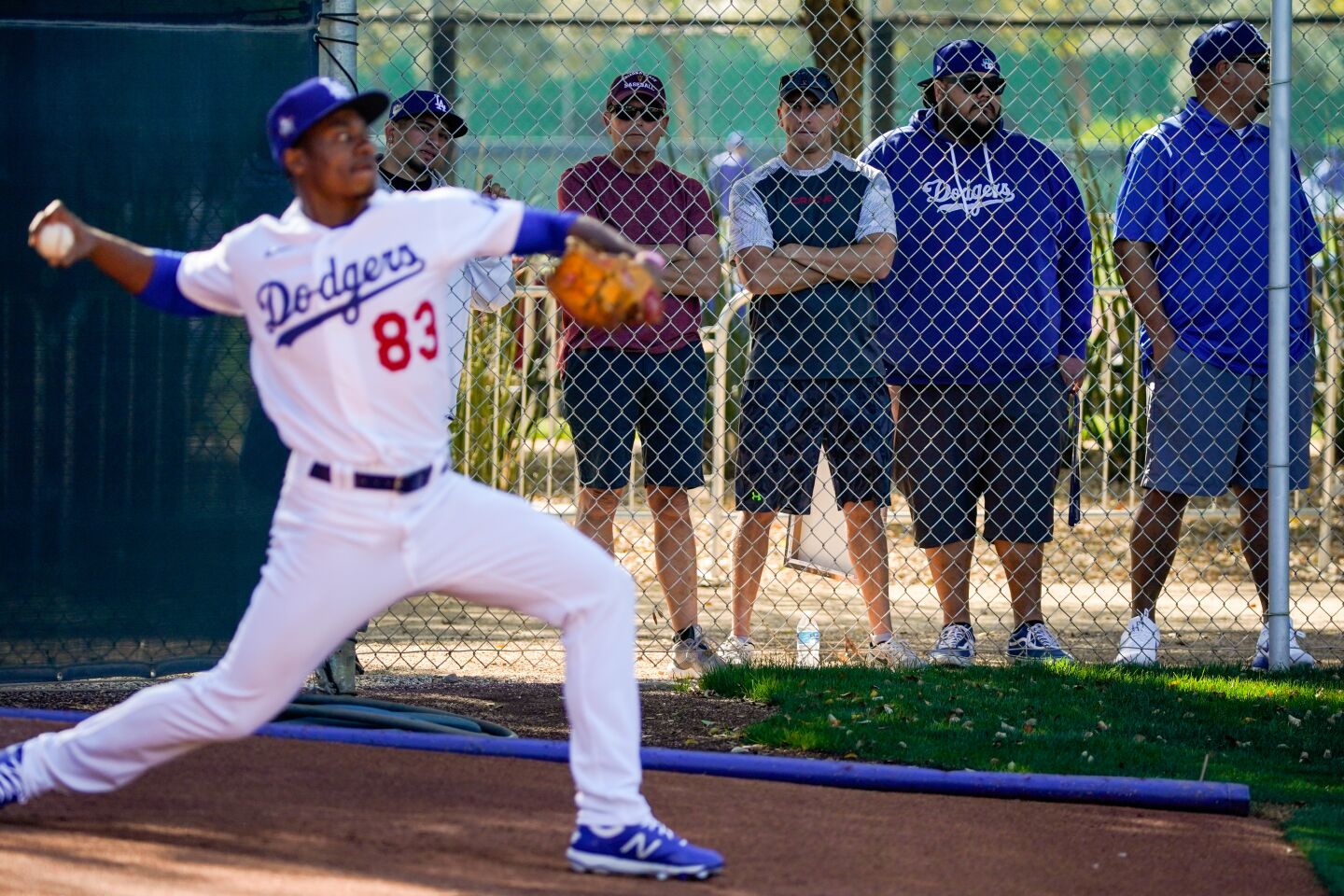 Dodgers fans watch pitcher Josiah Gray throw in the bullpen during spring training at Camelback Ranch.