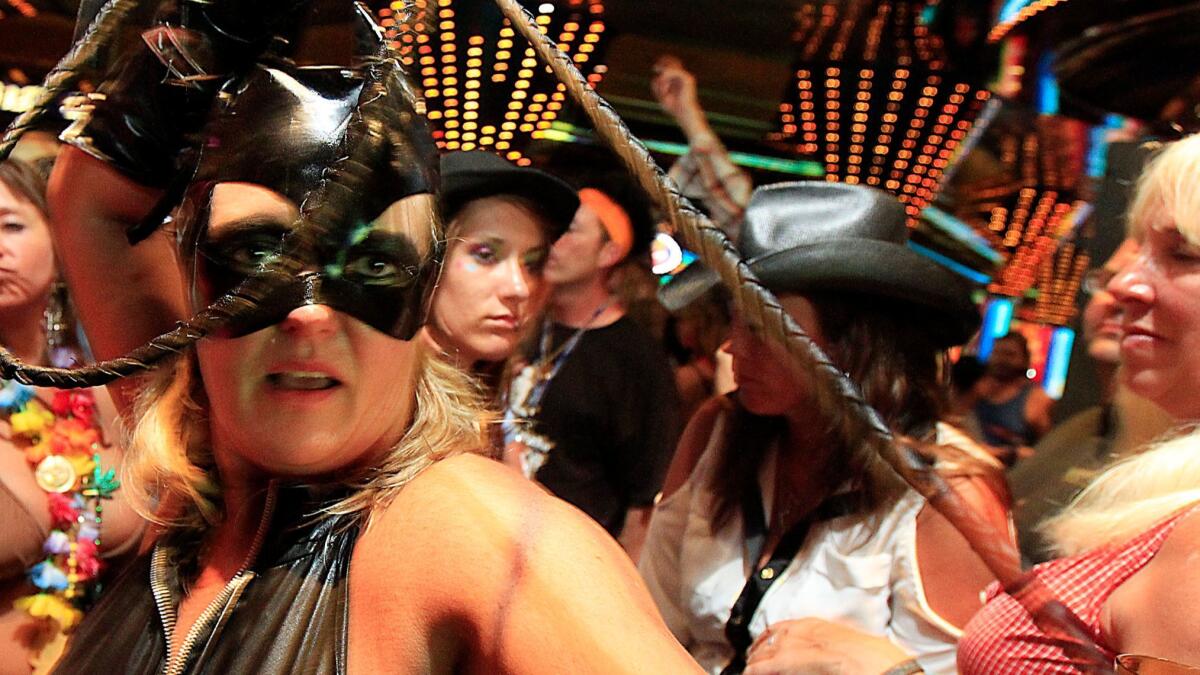 Catwoman joins the crowd during costume dance party aboard a Carnival ship. The line got high marks from dads, moms and bargain shoppers.