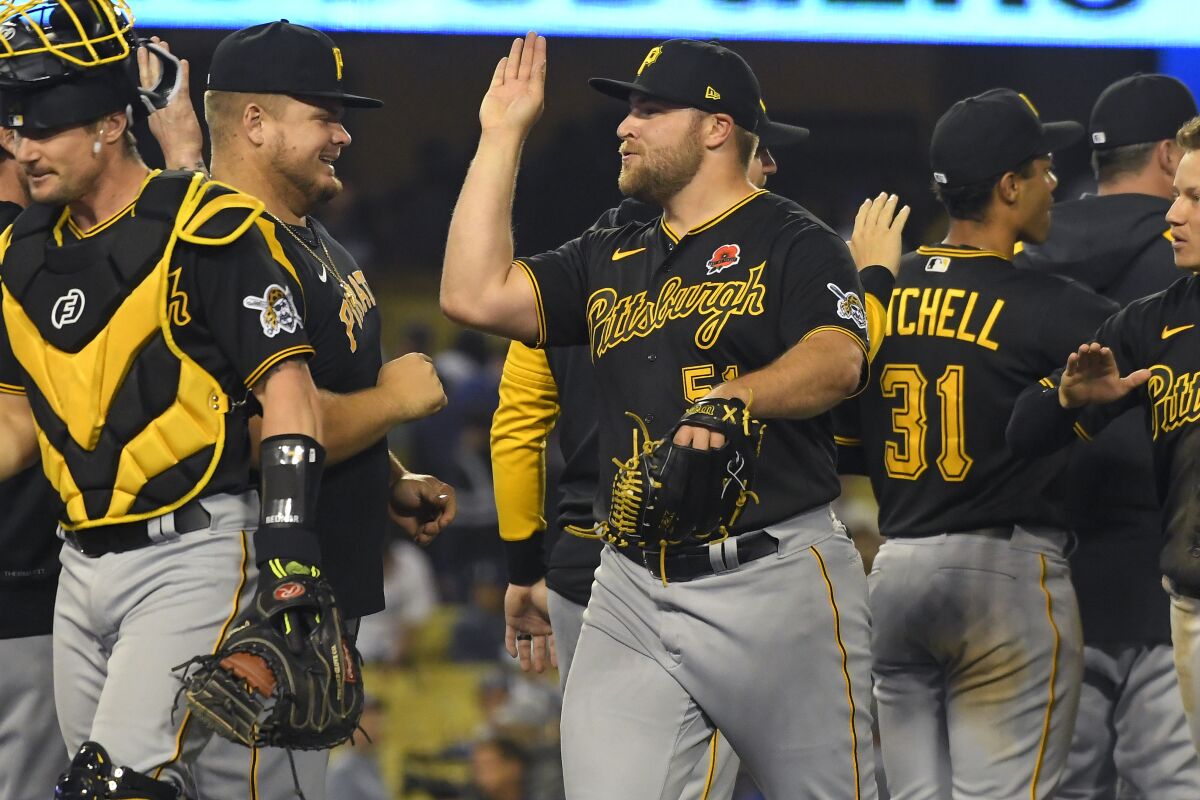 Pittsburgh Pirates relief pitcher David Bednar celebrates with his teammates.