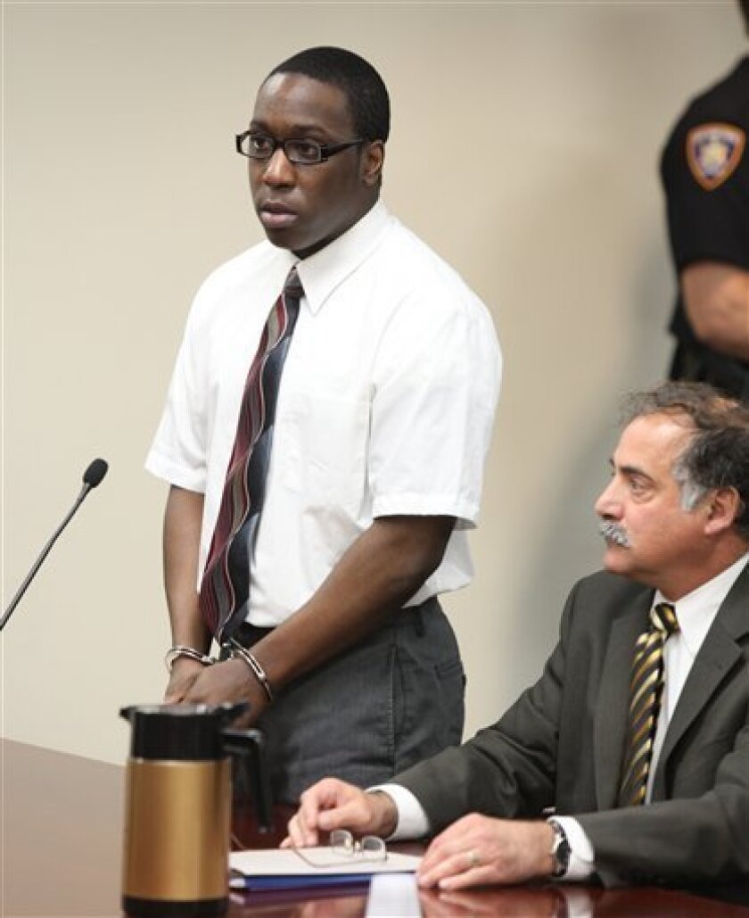 Riccardo McCray stands to address the court during his sentencing, Thursday, June 2, 2011 at the Erie County Courthouse in Buffalo, N.Y. McCray was sentenced to life without parole for shooting eight people outside a downtown Buffalo restaurant last summer, killing four. His attorney, Joseph Terranova, is at right. (AP Photo/Harry Scull Jr., Pool)