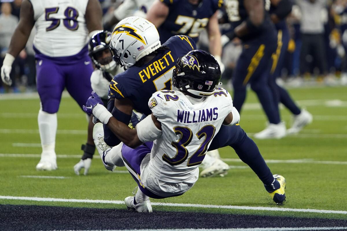 Gerald Everett backs into the end zone, knocking over Marcus Williams.