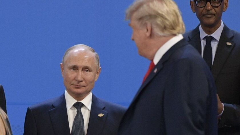 President Trump looks at Russia's president Nov. 30 during the G20 Leaders' Summit in Buenos Aires. The FBI opened an inquiry in 2017 into whether Trump was working on behalf of Russia, yhe New York Times has reported.
