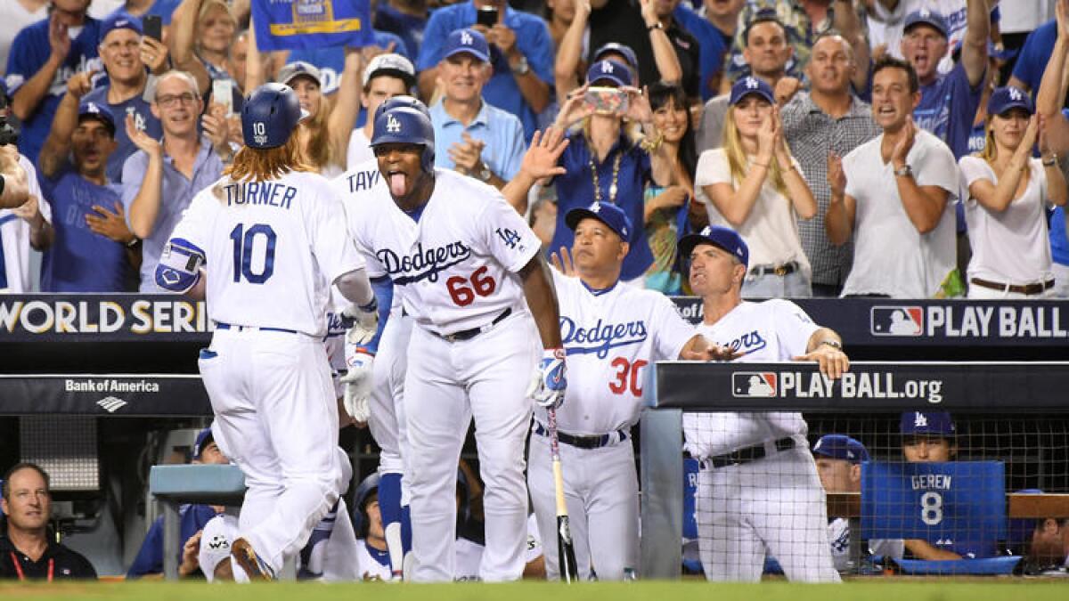 Justin Turner is greeted by teammates after his two-run homer.