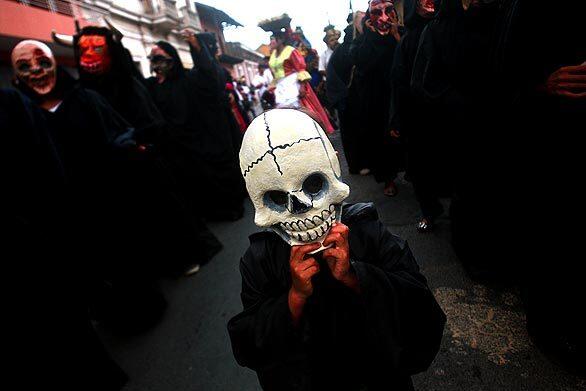 Masked celebrants participate in carnival festivities at the International Poetry Festival in Granada, Nicaragua.