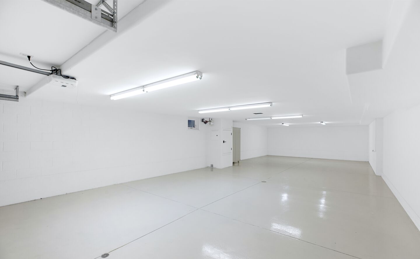 A white walled garage with tile flooring