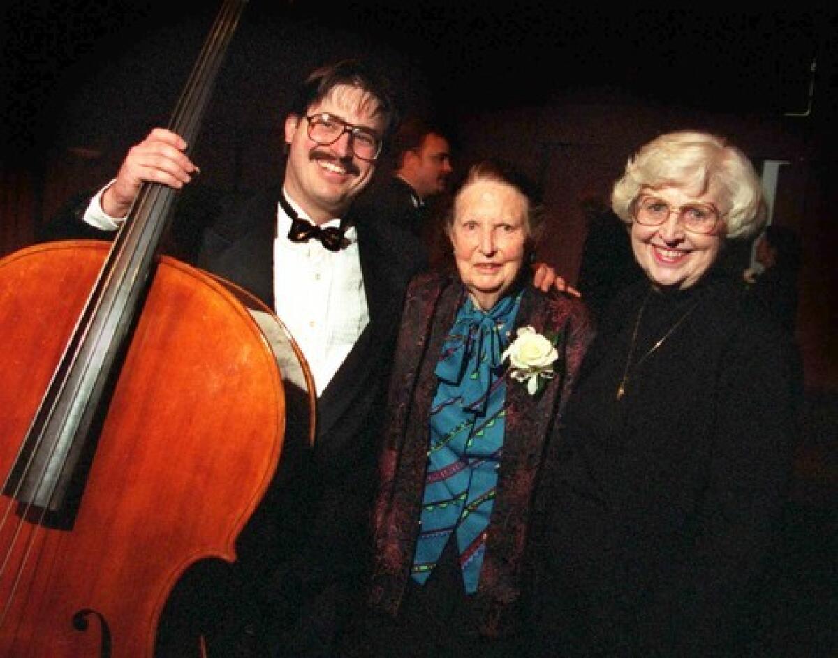 Violin maker Carleen Hutchins, center, is flanked by Joe McNalley and his mother, Sharon, after the inaugural performance by the Hutchins Consort.