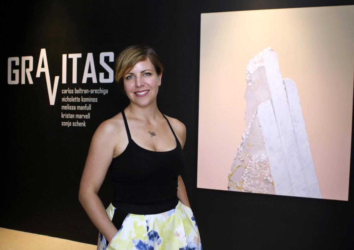 Shannon Currie Holmes, exhibitions supervisor for the Brand Library & Art Center, in front of work called "Prime," by Sonja Schenk.