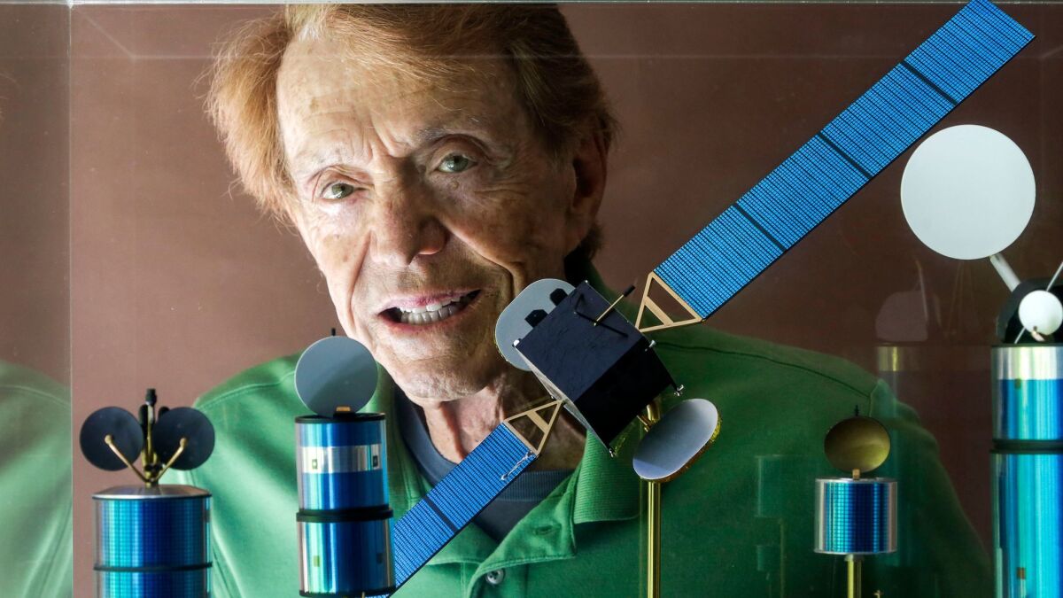 Harold Rosen, shown through a showcase of models of his satellites at his home in Santa Monica in 2013.