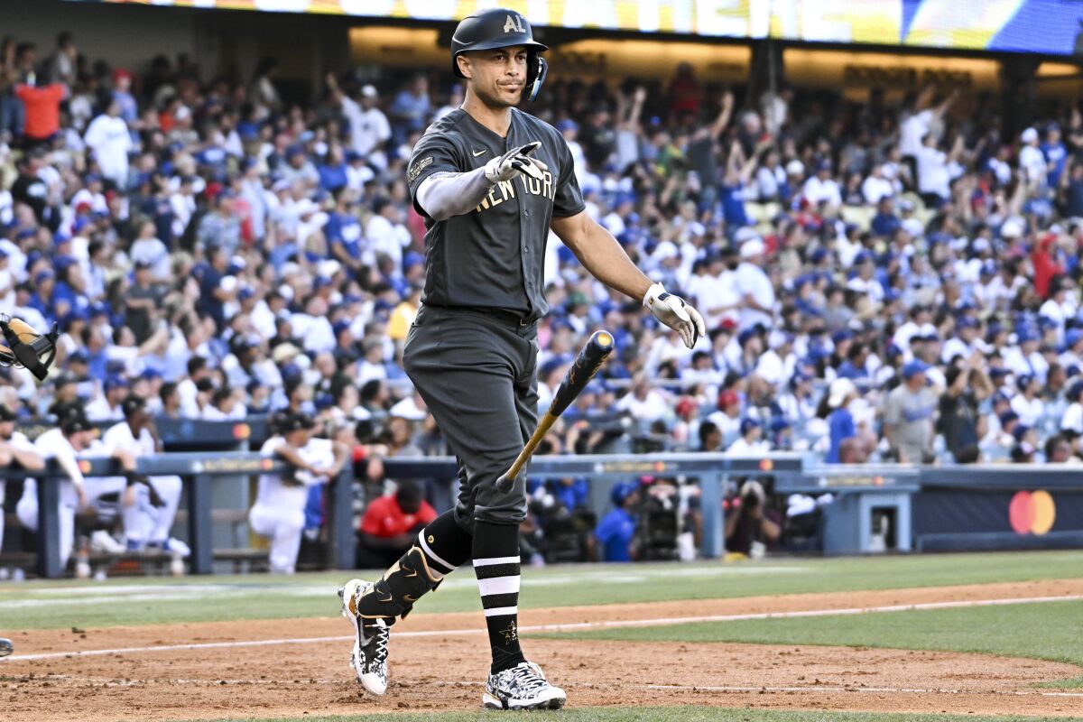 American League outfielder Giancarlo Stanton, of the New York Yankees, tosses his bat after a home run.