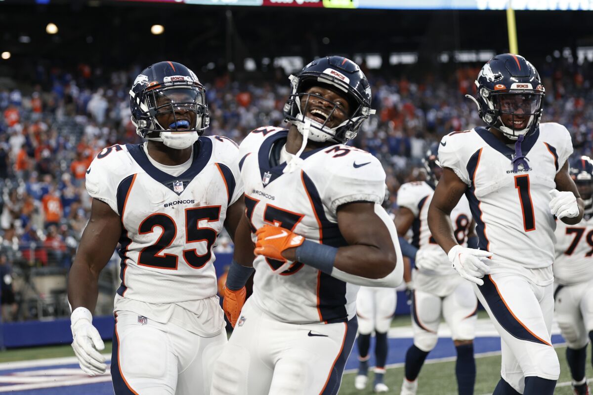 Denver Broncos' Melvin Gordon (25) celebrates with Javonte Williams (33) and K.J. Hamler (1) after scoring a touchdown during the second half of an NFL football game Sunday, Sept. 12, 2021, in East Rutherford, N.J. The Broncos won 27-13. (AP Photo/Adam Hunger)
