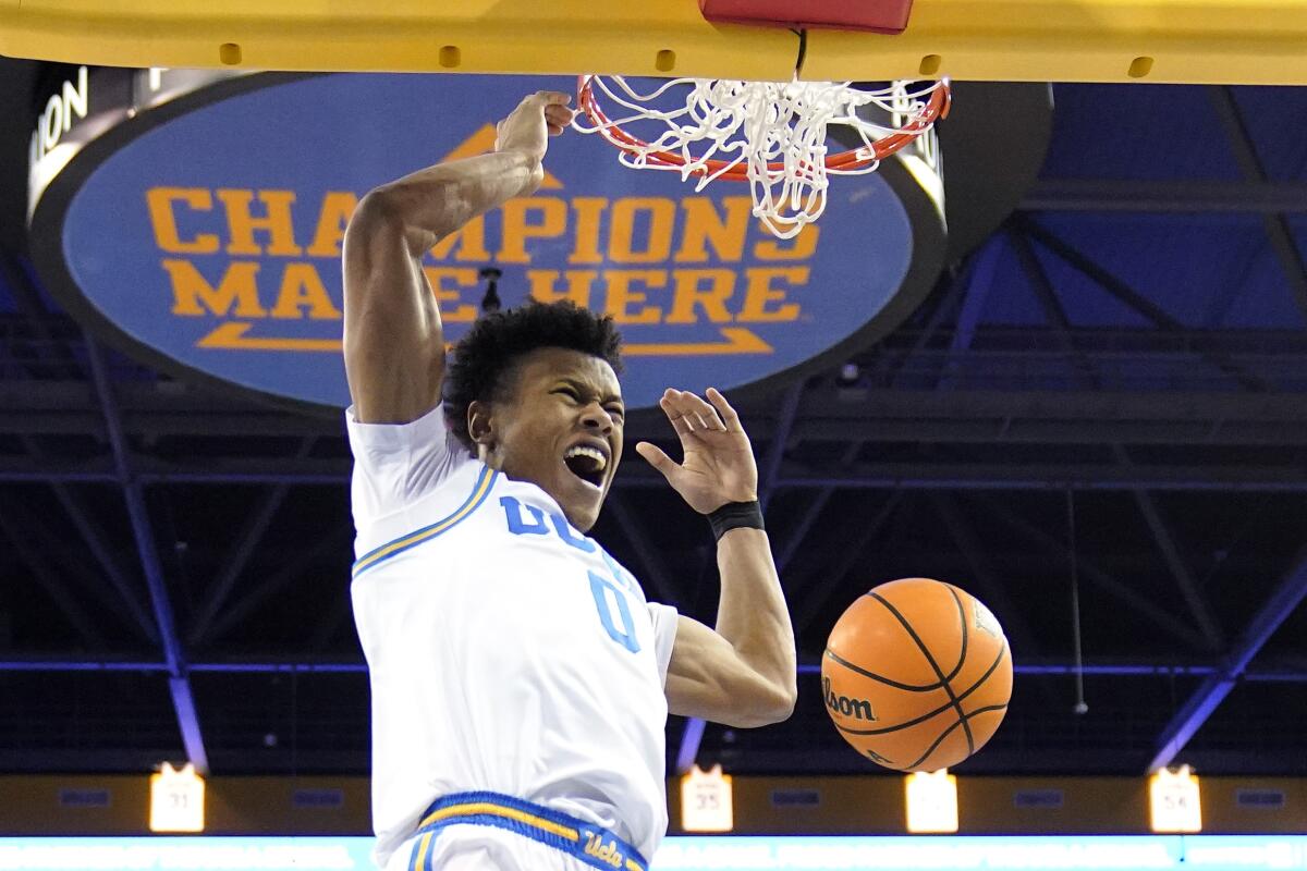 UCLA guard Jaylen Clark dunks during the first half of an NCAA college basketball game.