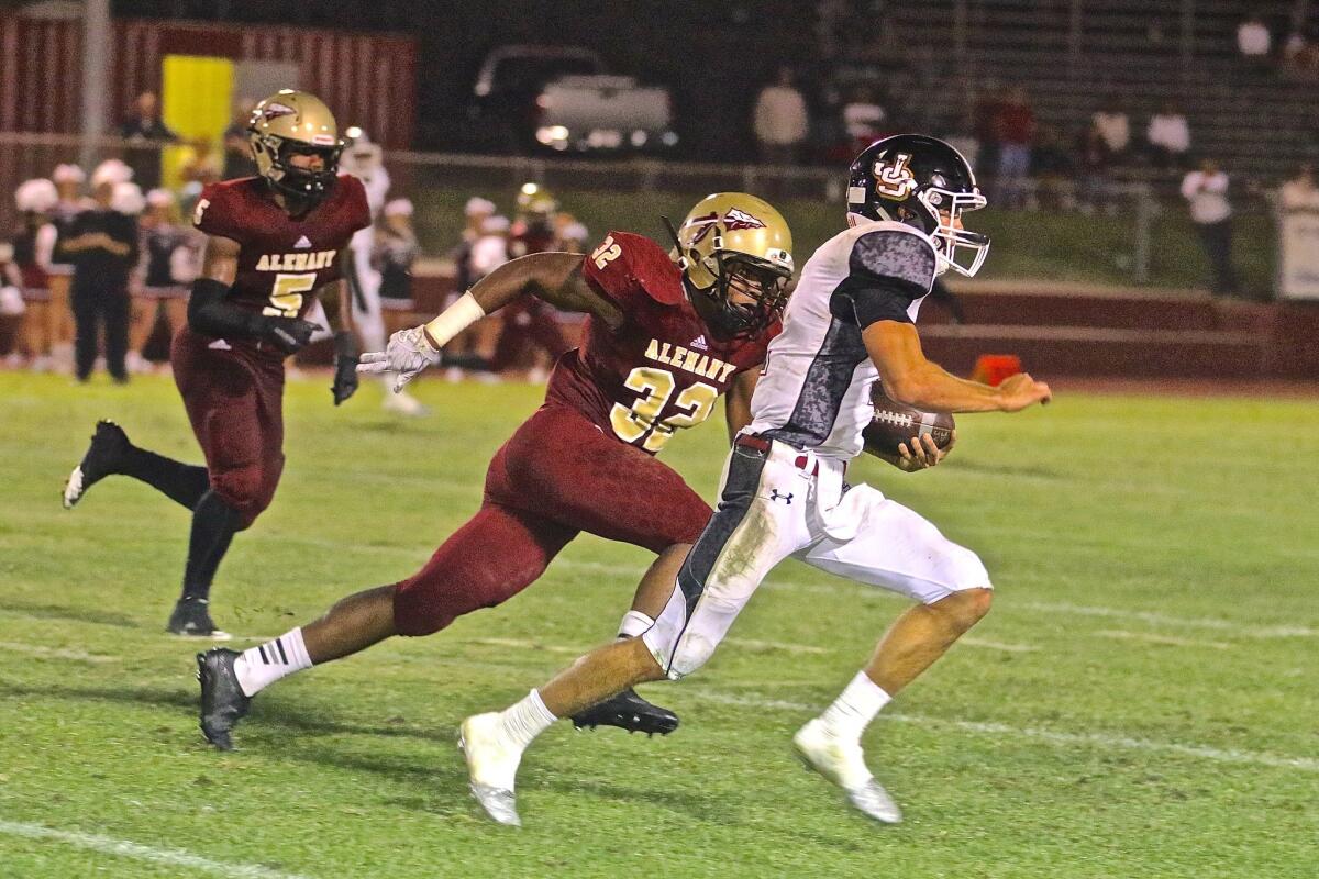 JSerra quarterback Matt Robinson runs for a first down in the fourth quarter of Friday's nonleague game against Alemany in Mission Hills. He threw for three touchdowns in the Lions' 28-27 overtime victory.