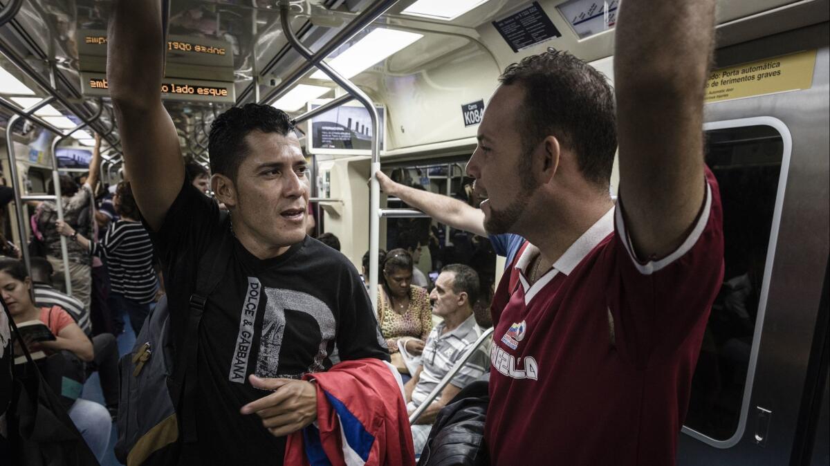 Teoscar Mata, 29, right, and his uncle, Luis Baena, 42, ride a subway train in Sao Paulo, Brazil.