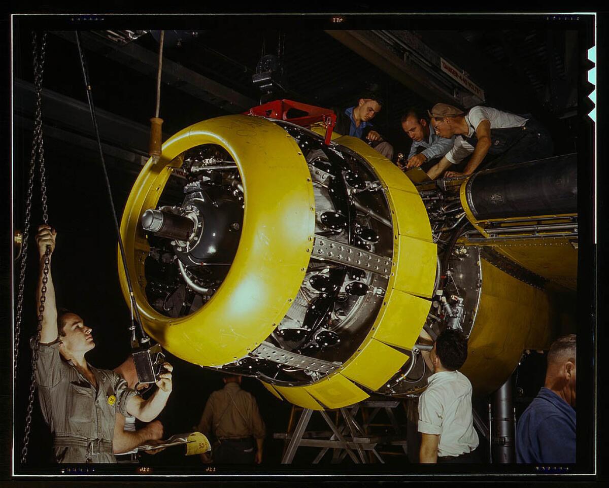 Mounting motor on a B-25 bomber at North American Aviation Inc. plant in Inglewood in 1942.