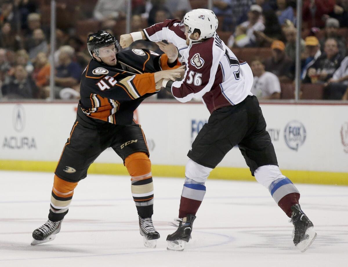 Ducks defenseman Josh Manson, left, trades punches with Colorado's Daniel Maggio during the first period of an exhibition game on Sept. 22.